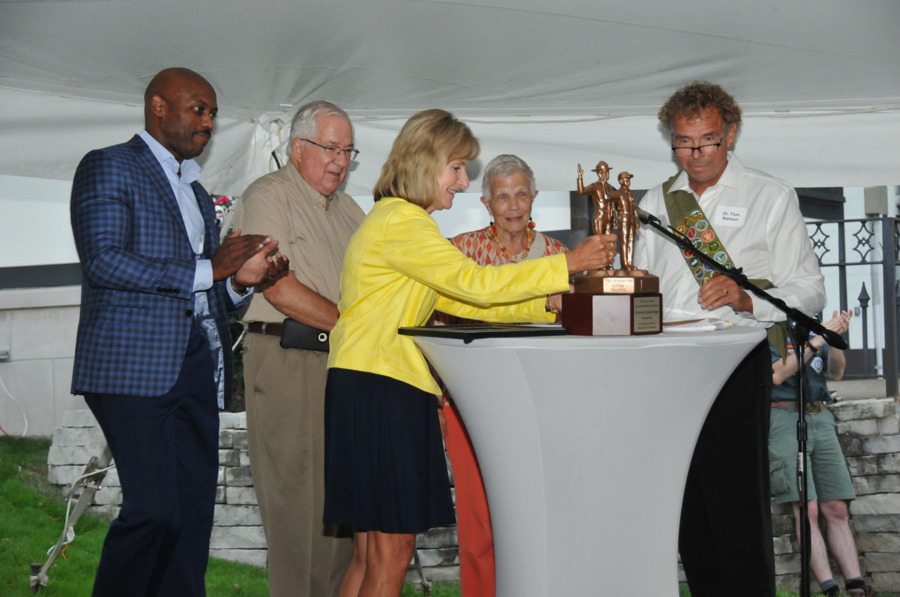 Dr. Kathy Bohn presenting the Good Scout award to Jerry and Carole Ringer